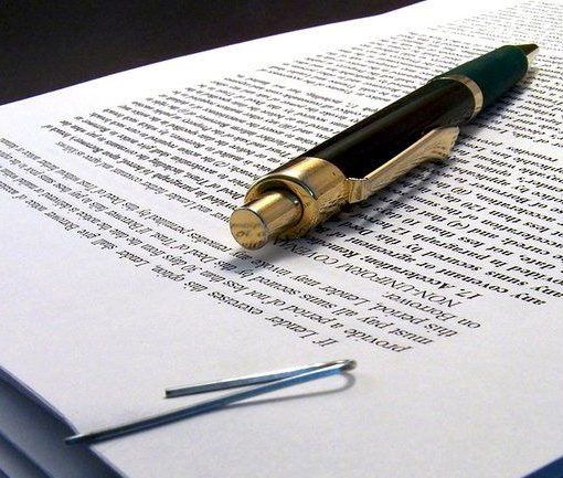 Acute and Chronic MSK Image A person grasping their ankle while sitting on a floor.