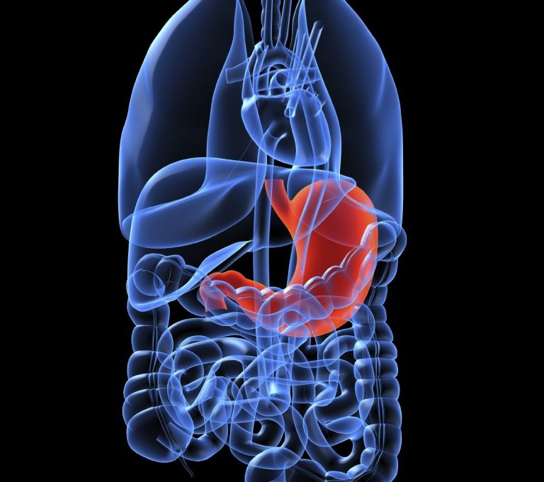 Acute and Chronic MSK Image A person grasping their ankle while sitting on a floor.